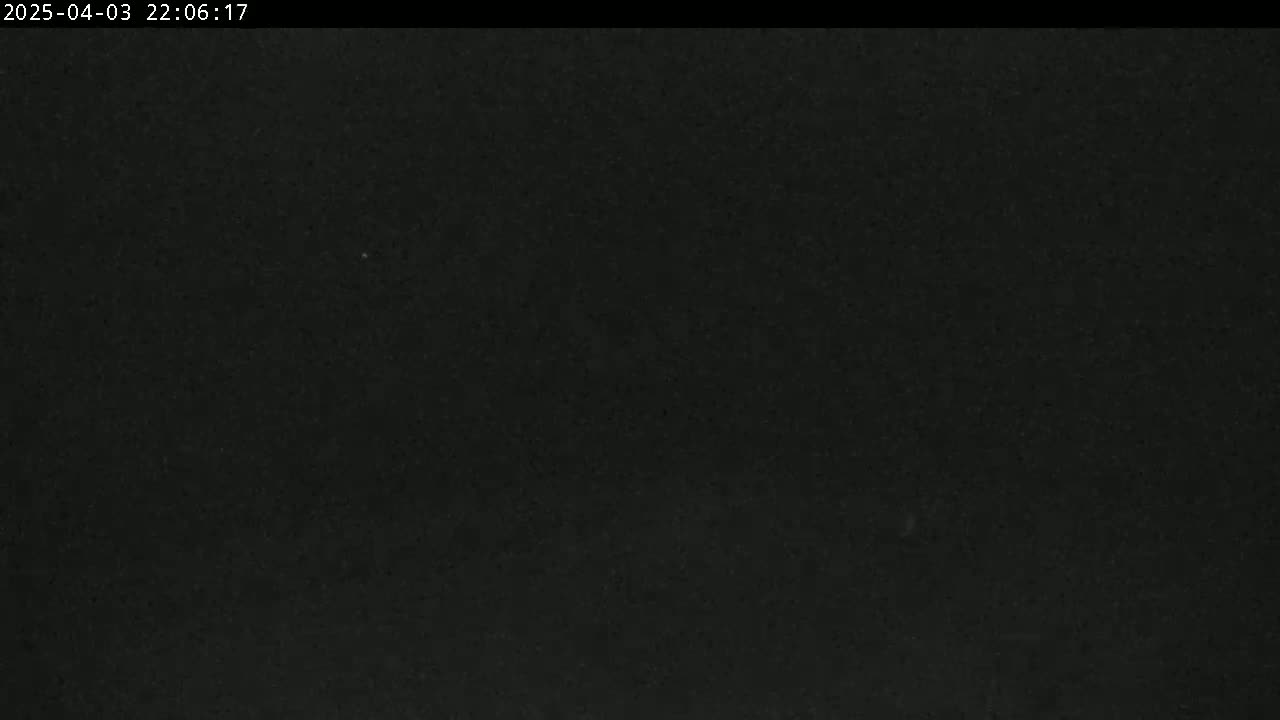 The image shows a uniformly dark, possibly nighttime, scene with a slightly grainy texture.