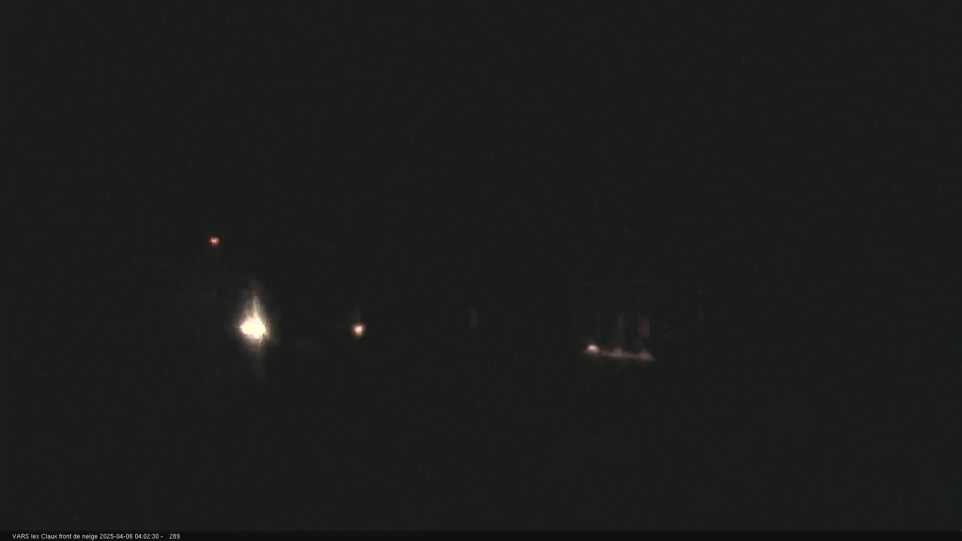 Faint lights are visible in the darkness of night.
