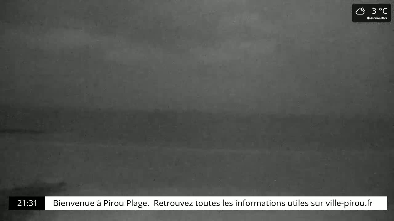 A dark, blurry image of a beach at night, under cloudy skies with a temperature of 3°C.