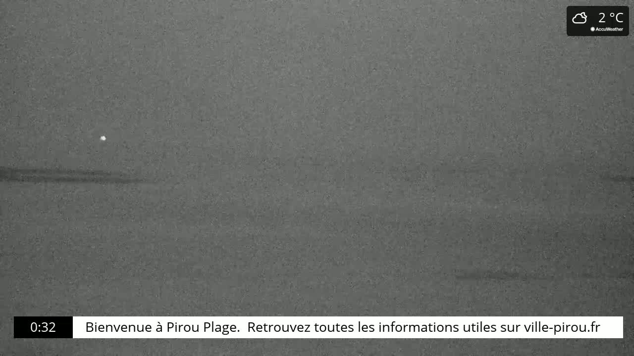A dark, grainy nighttime image of a seemingly calm body of water under cloudy skies at 2°C.