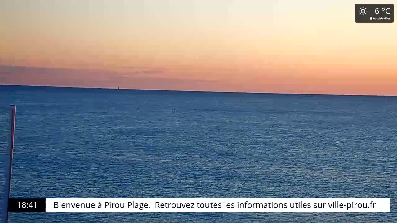 A calm ocean under a pinkish-orange sunset sky.