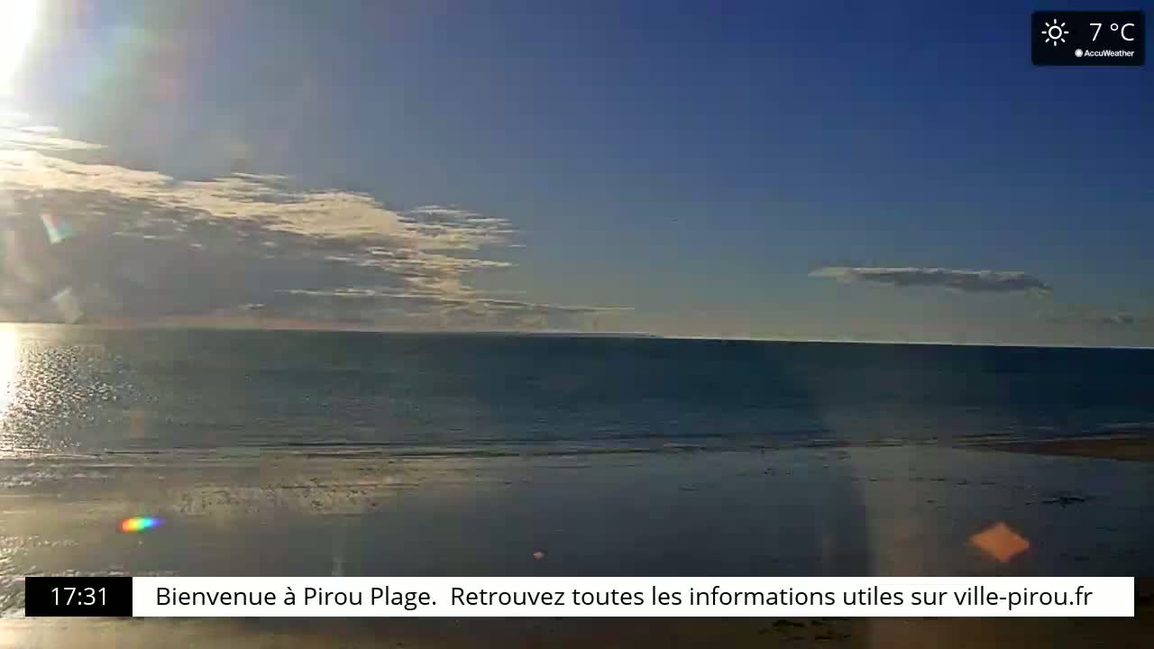 A mostly clear, sunny day with a few clouds shows a calm ocean meeting a sandy beach at 7°C.