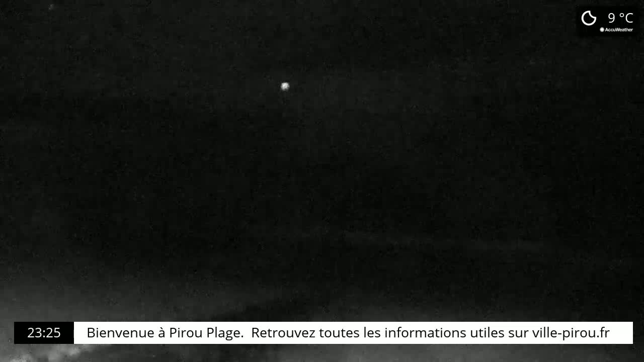 A dark, nighttime scene shows a faint, bright light in the distance under a mostly clear, 9°C sky.