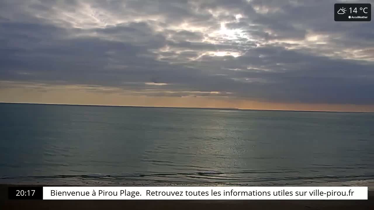 A calm ocean meets a partly cloudy sky at sunset.