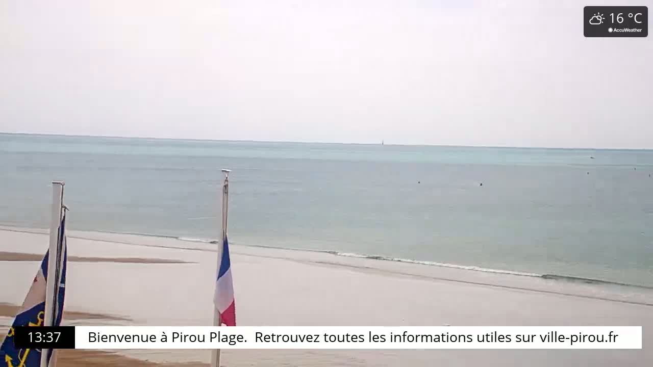 A calm, light-blue ocean meets a pale, sandy beach under a cloudy, 16°C sky.