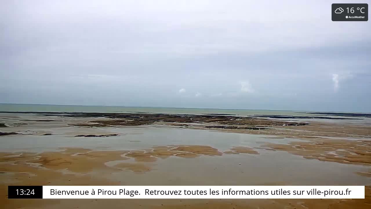 A mostly cloudy, 16°C day at a beach shows a wide expanse of wet sand and exposed rock formations leading to a calm ocean.