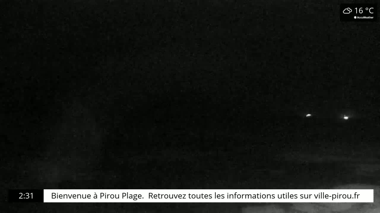 A nighttime, low-light image shows two distant lights in the darkness, with cloudy weather at 16°C.