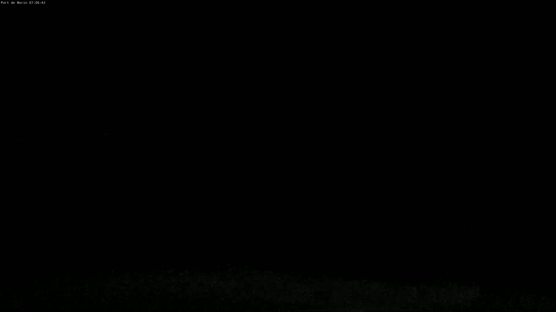 The image is almost entirely black, with a faint, barely visible, textured line at the very bottom.