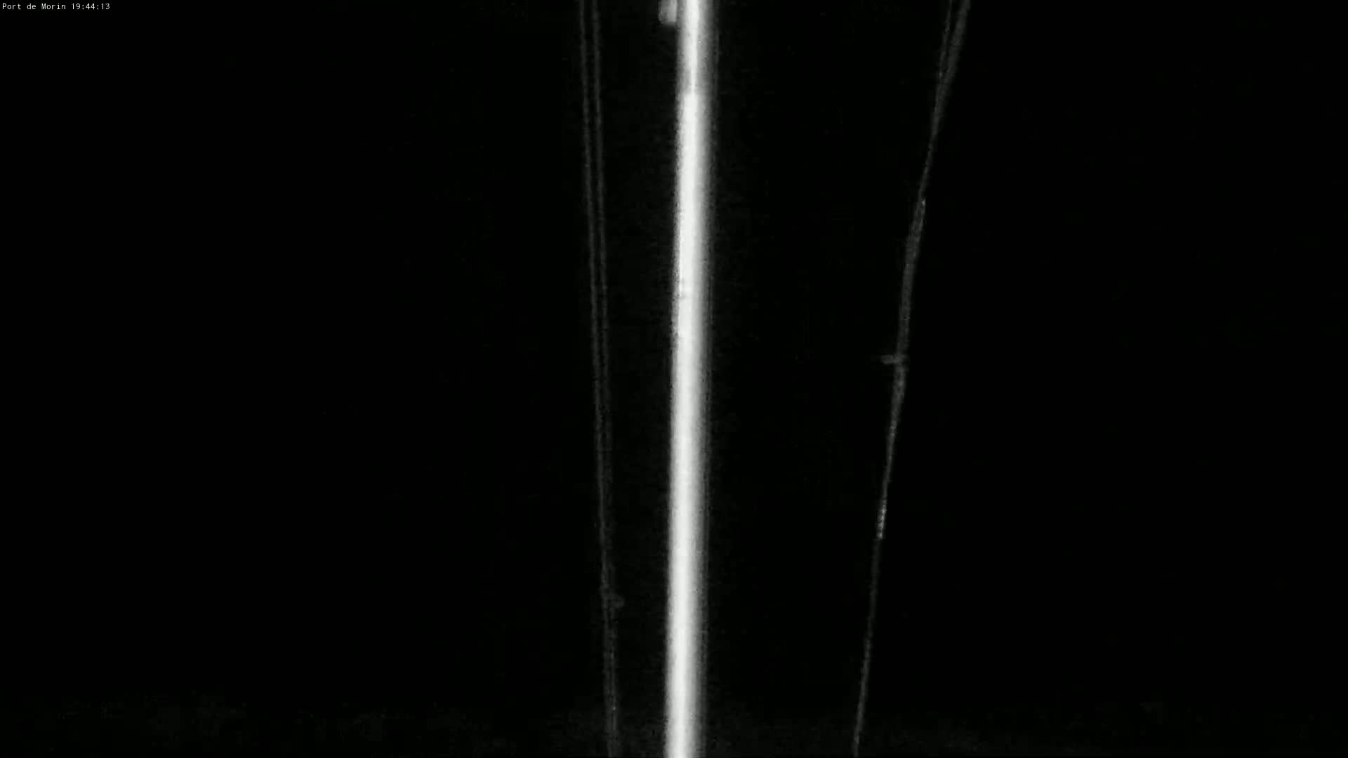 A bright vertical line is visible against a dark background, flanked by two fainter, vertical lines.