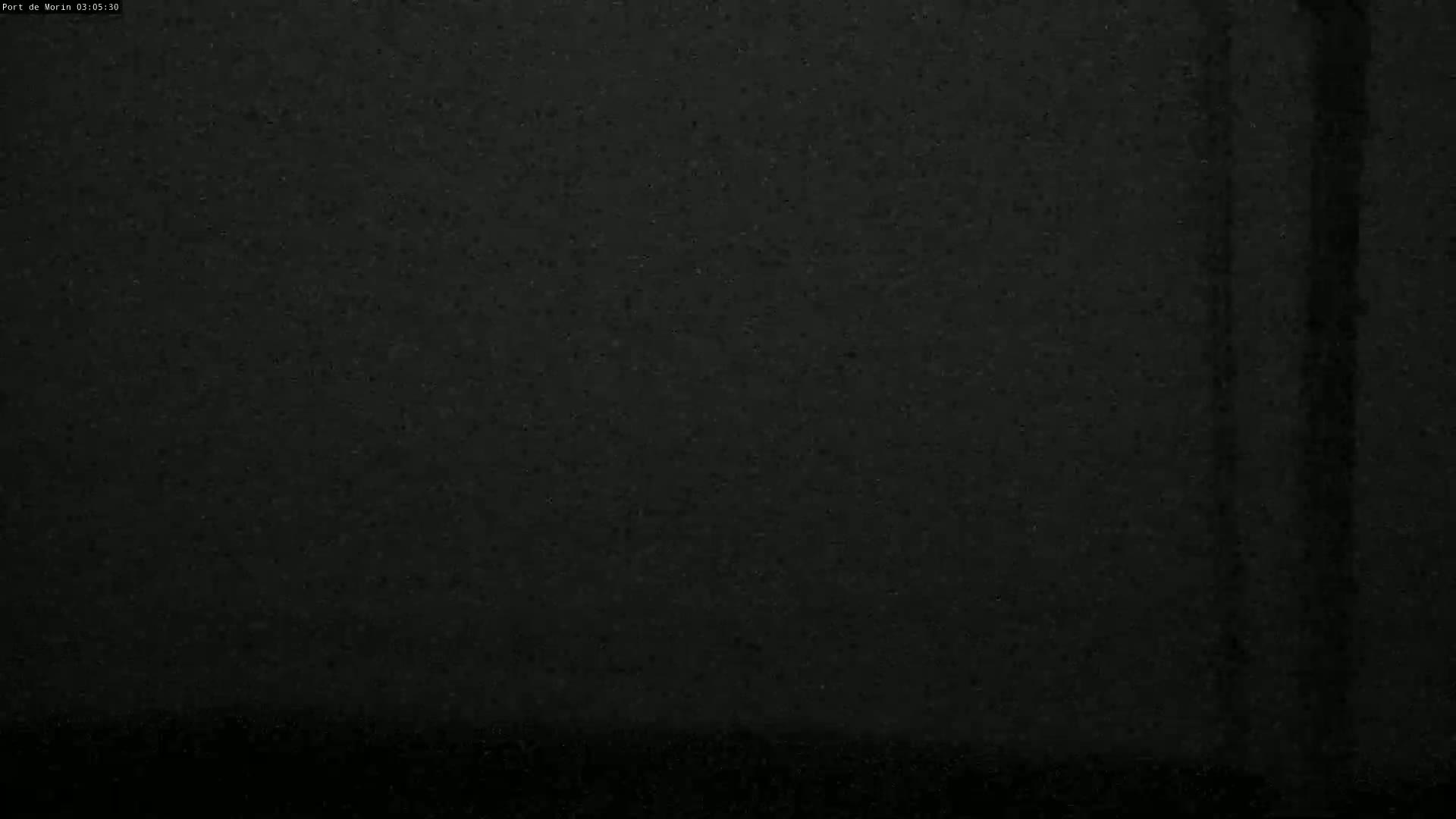 A dark, grainy image shows a mostly black surface with faint vertical streaks.