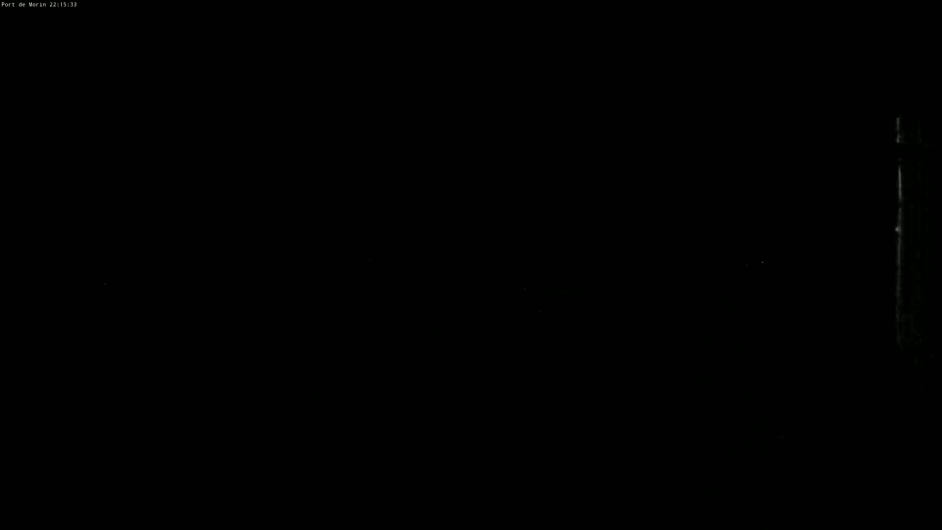 The image is almost entirely black, with a faint, vertical, light gray line on the right.