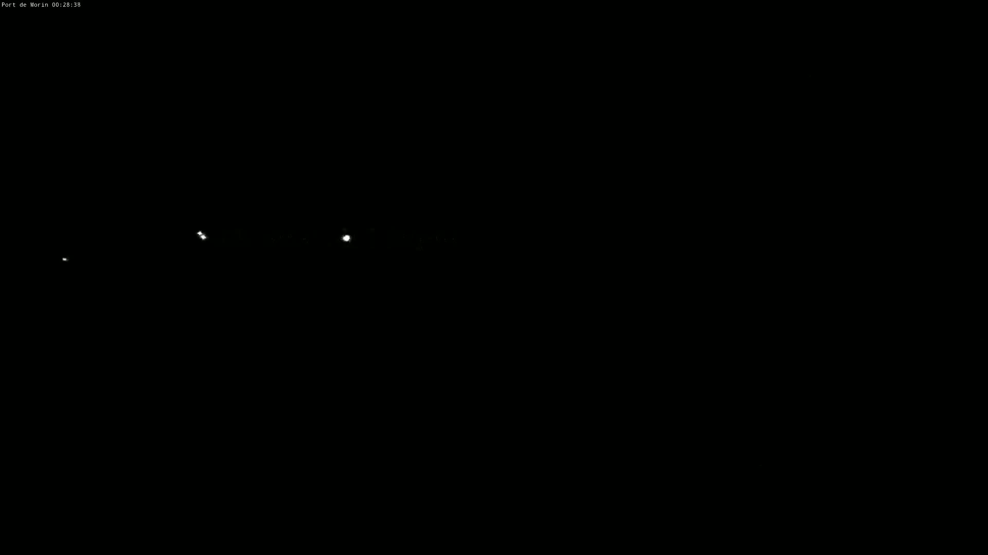 Several small, bright lights are visible in the dark night sky.