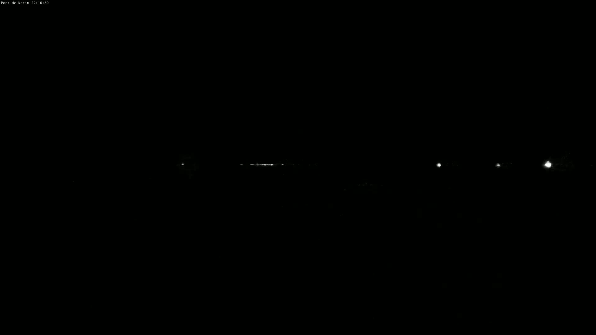 A long, faint line of lights is visible in the distance at night.