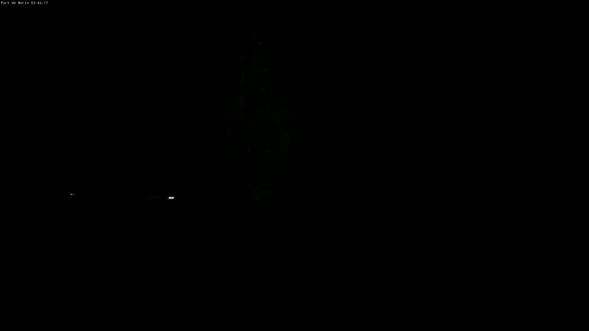 Faint lights are visible in the distance during a dark night.