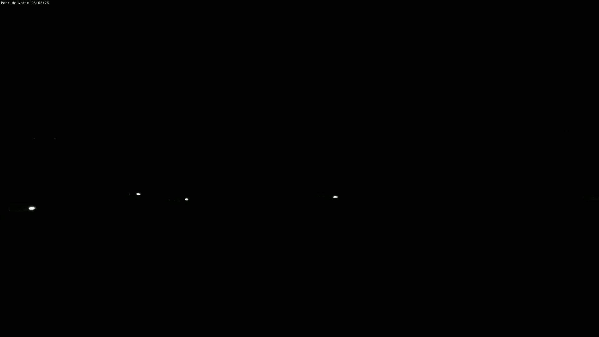 Several small, faint lights are visible in the dark night.