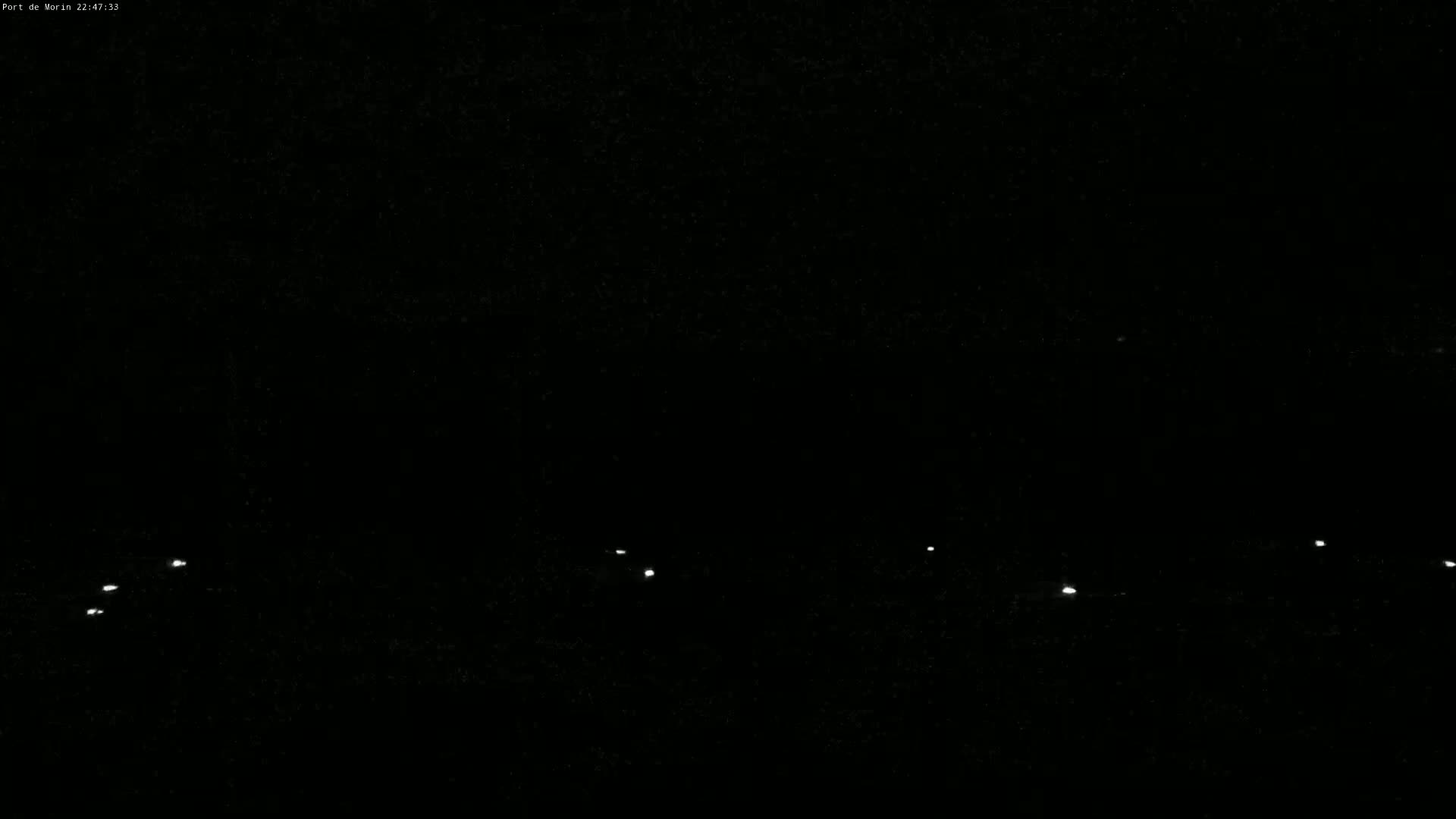 Several small, faint lights are visible in the dark.
