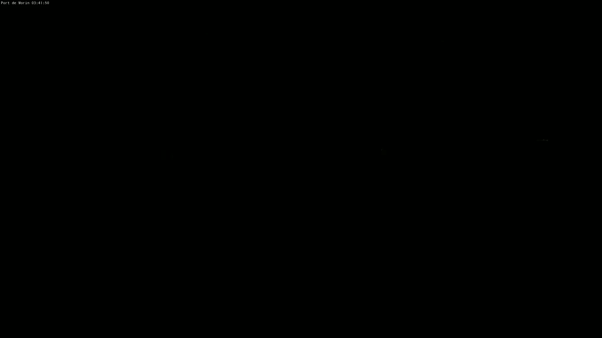 The image is completely black except for a few faint green pixels.