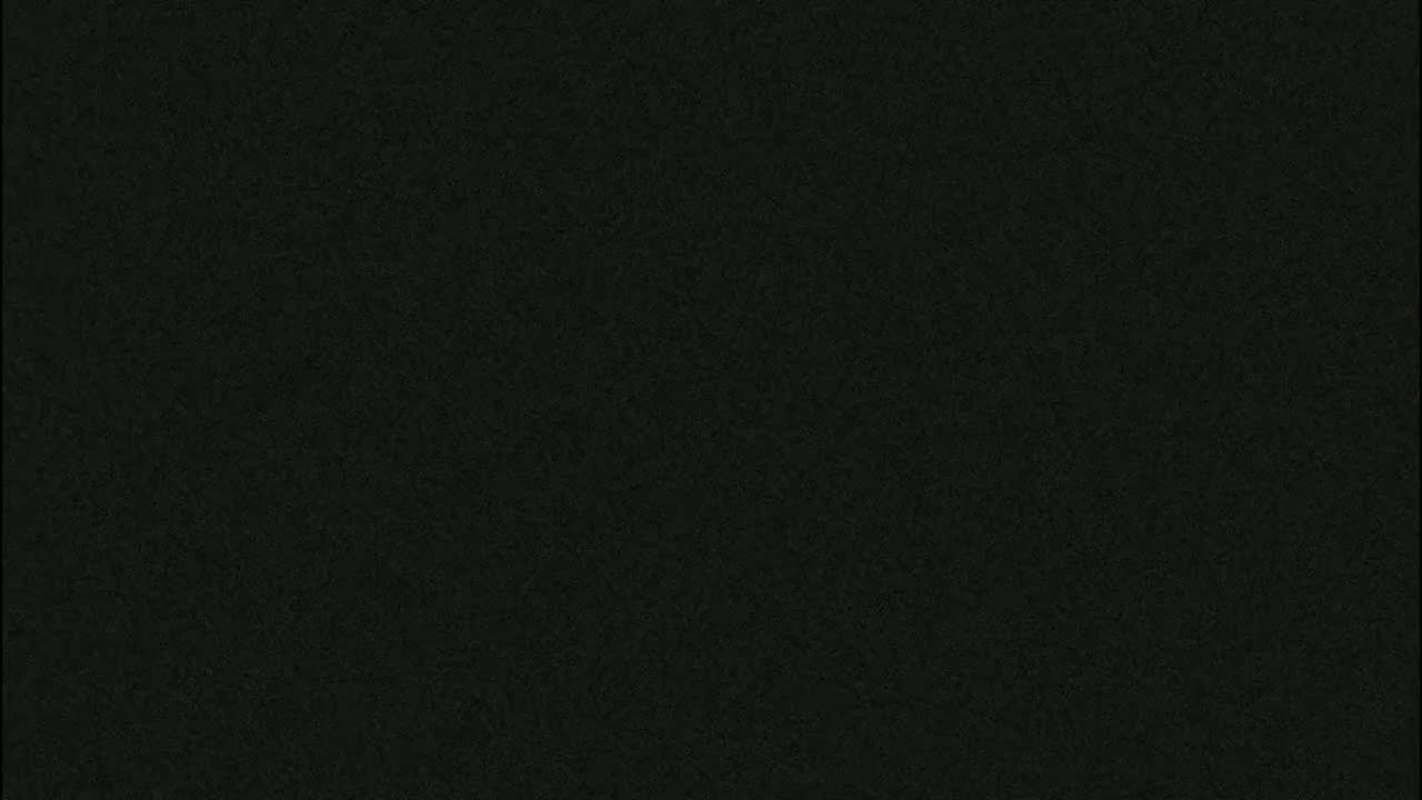 The image shows a dark, textured surface that appears to be uniformly dark gray or black.