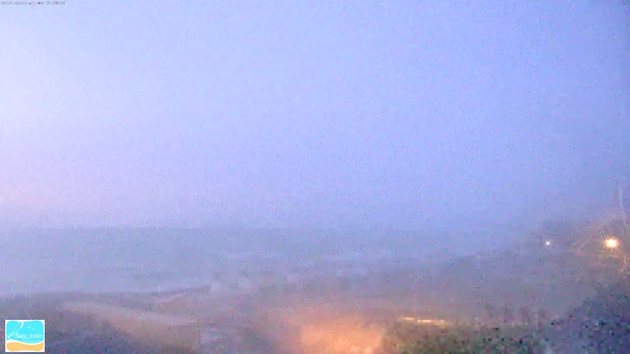 A hazy, foggy landscape is visible at twilight.