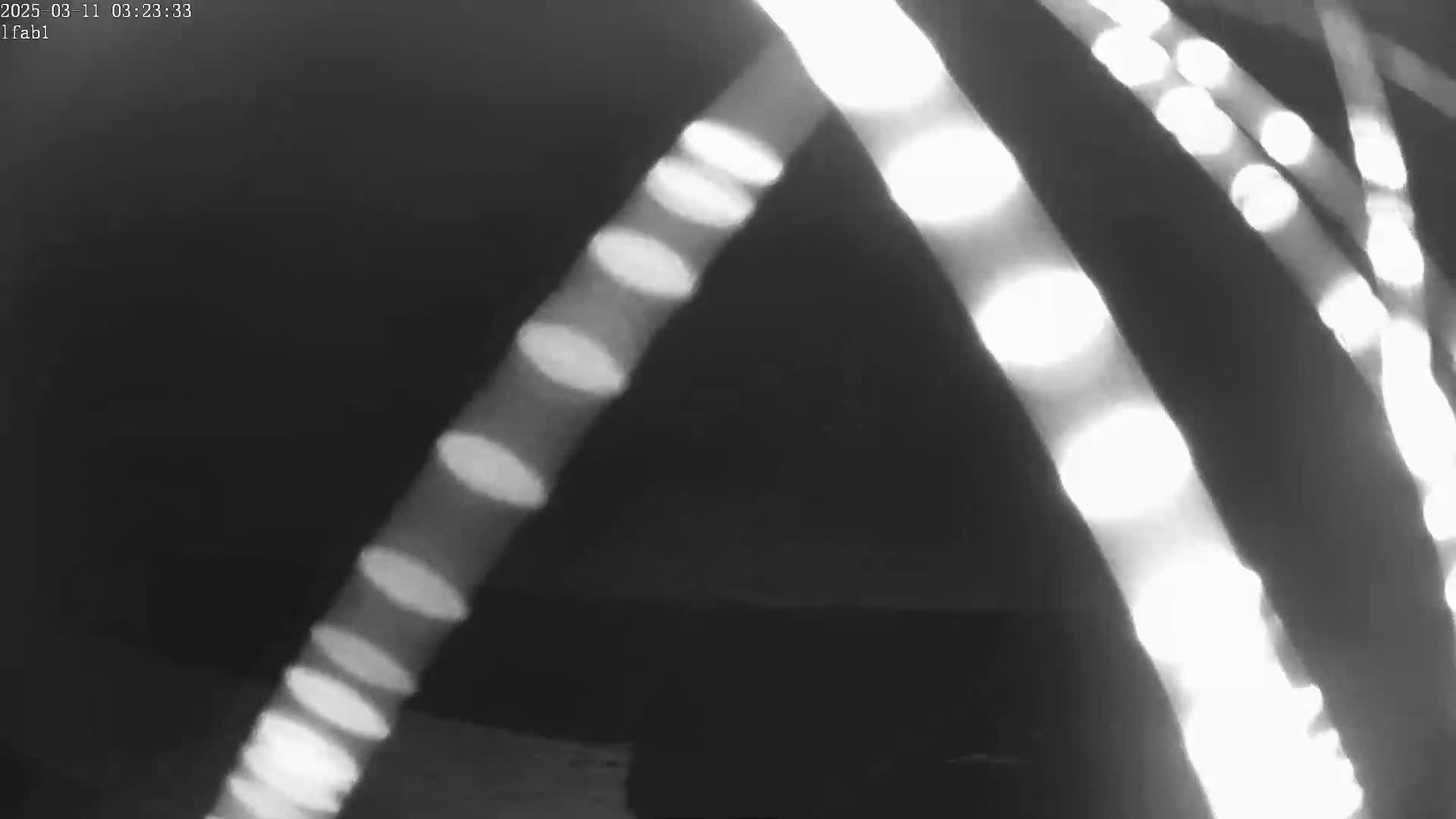 Several bright, elongated streaks of light appear against a dark background.