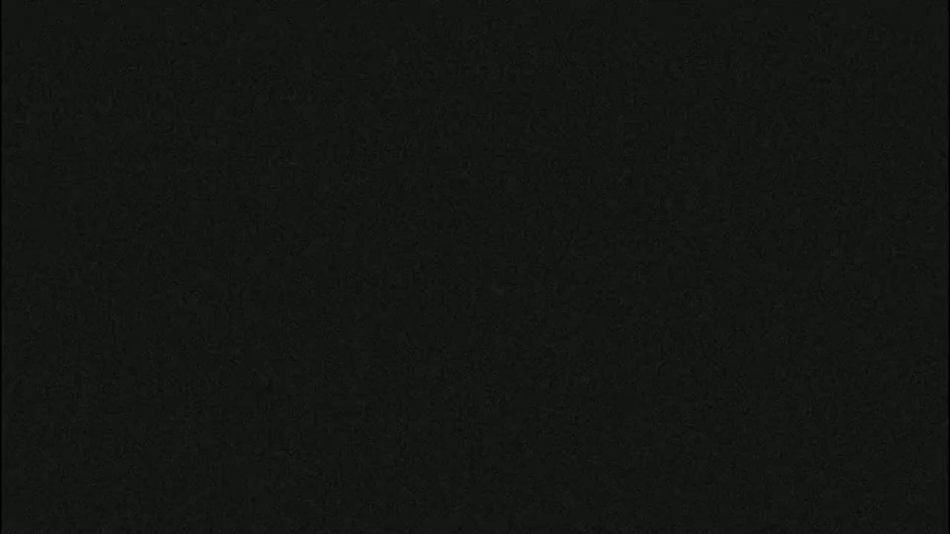 The image shows a solid black textured background.