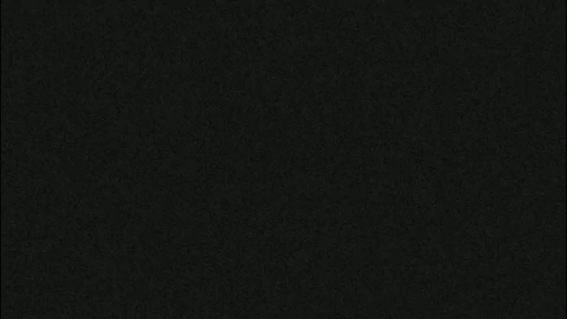 The image is a solid dark-grey background with a slightly textured surface.