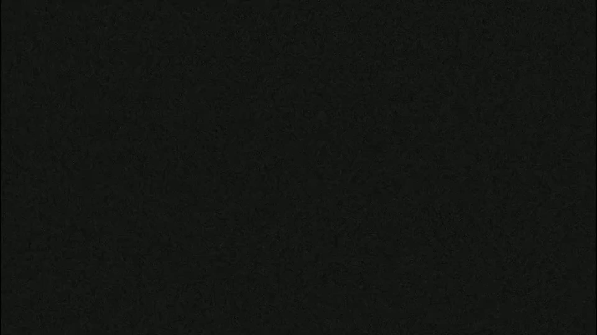 The image is a solid dark gray or black textured background.