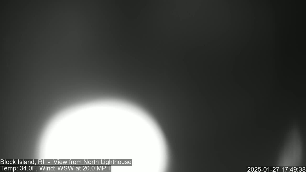 A bright, blurry white light dominates the bottom center of a dark, overcast image.