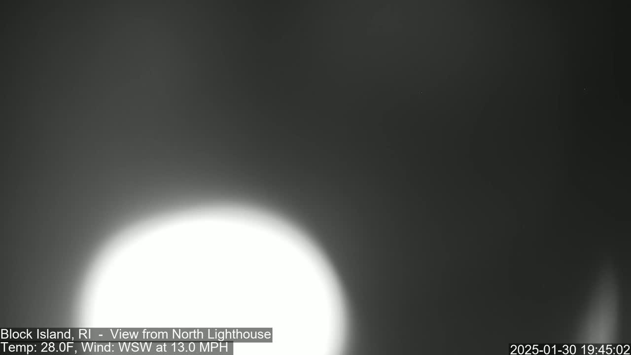 A bright, blurry white light dominates a dark, nighttime scene with a wind of 13 mph from the west-southwest.