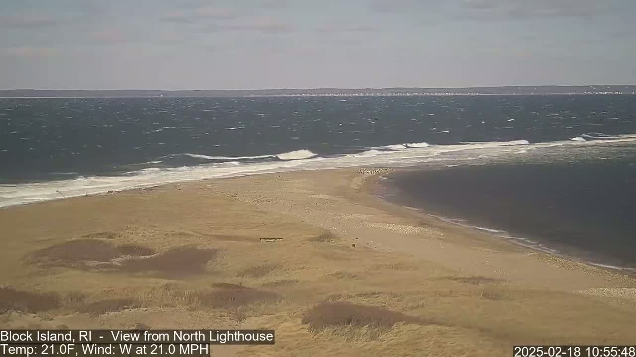 A windy, 21°F day shows a sandy beach and a spit of land jutting into a choppy ocean.