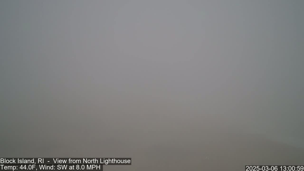 A thick fog obscures the view in an outdoor setting.