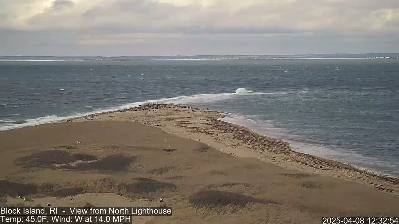 A windy, 45°F day shows a sandy shoreline with a small spit of land jutting into a choppy sea.