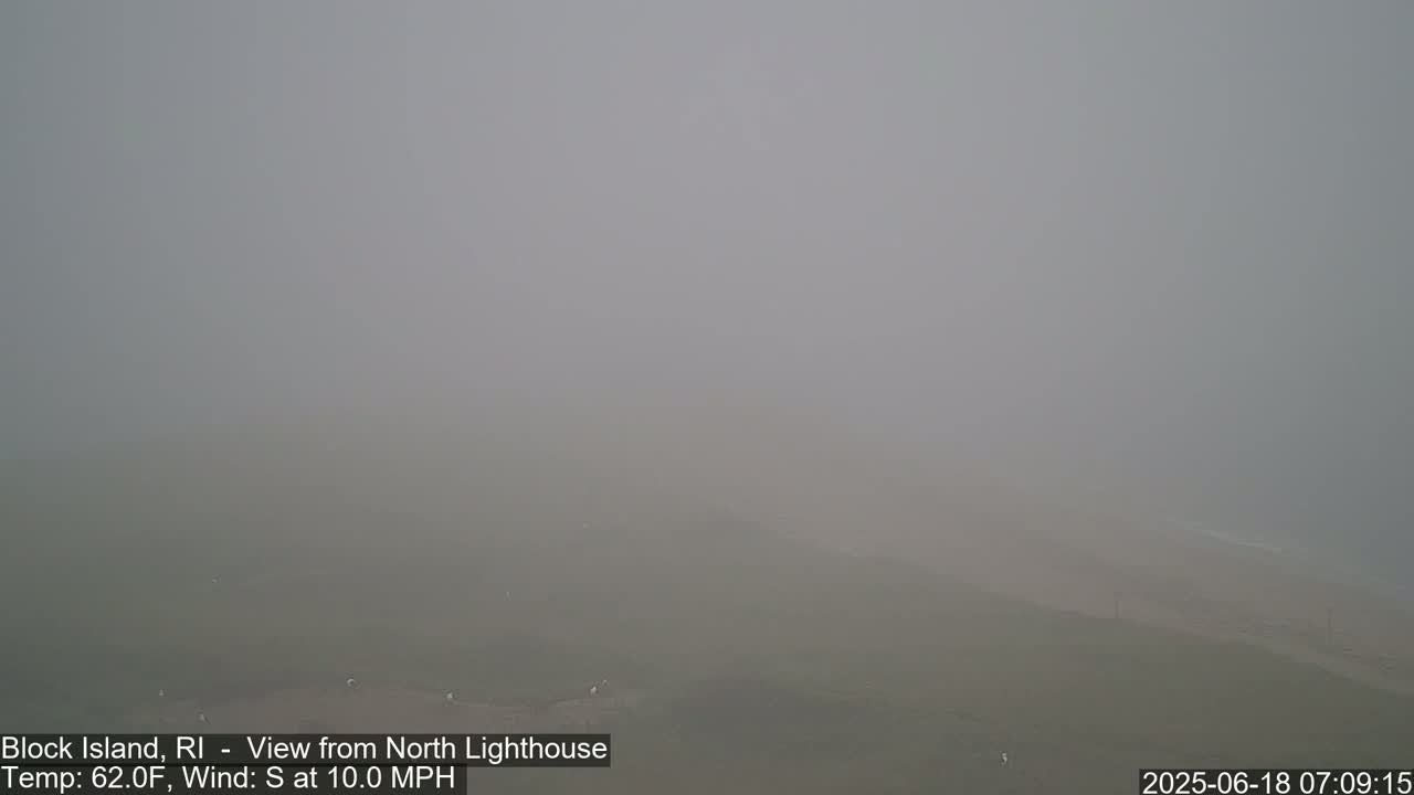 A foggy, flat expanse of land and water is visible, with a light south wind.