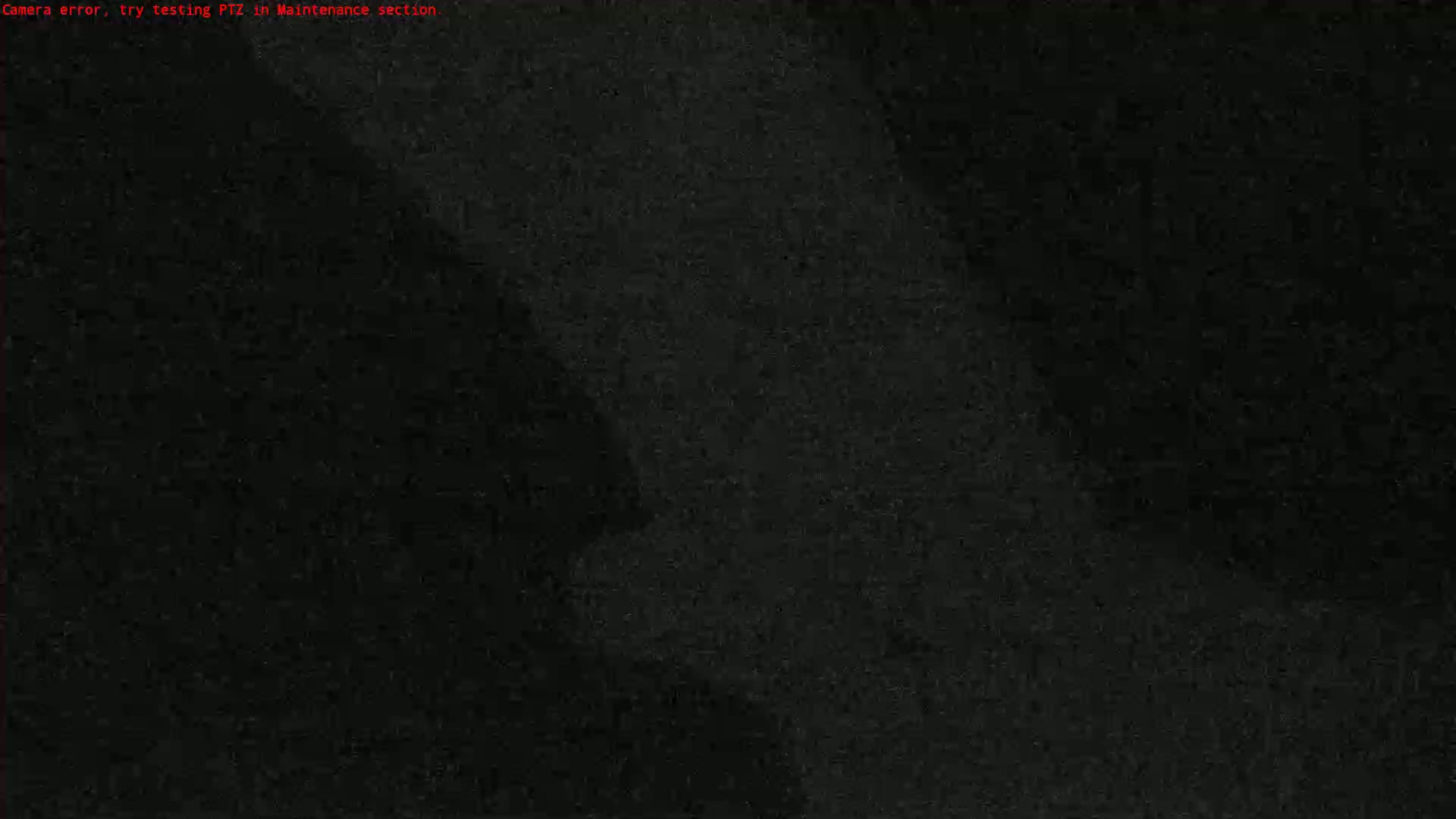 The image shows a mostly black screen with a slightly lighter, blurry area in the upper right corner.