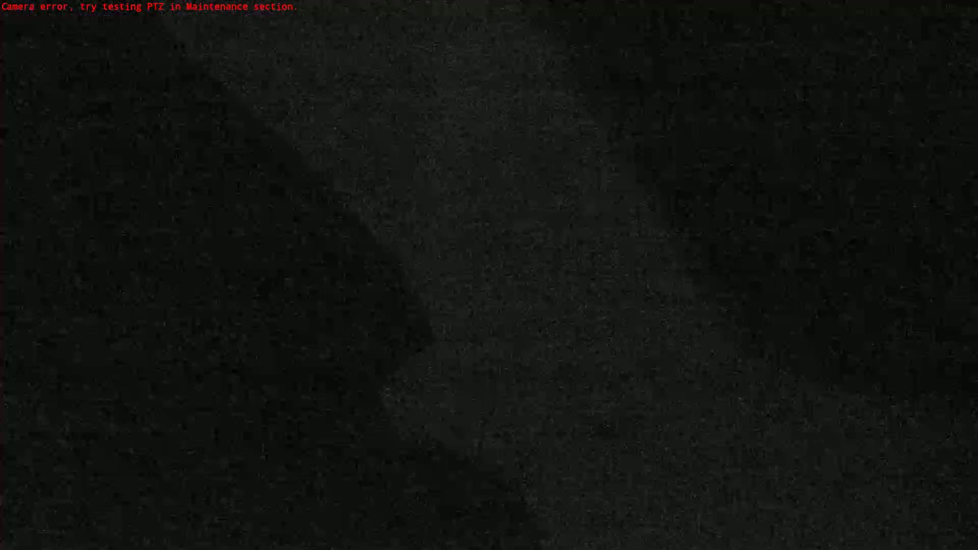 A grainy, dark image shows mostly black with some lighter gray areas.