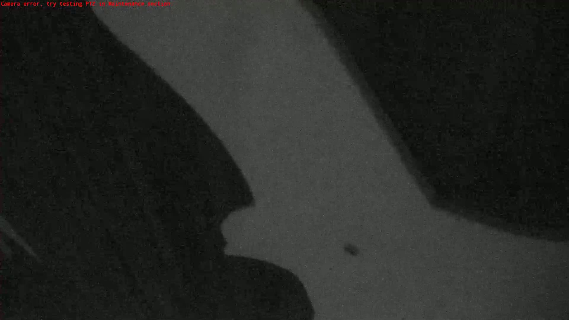 A grainy, dark gray image shows shadows cast on a surface.