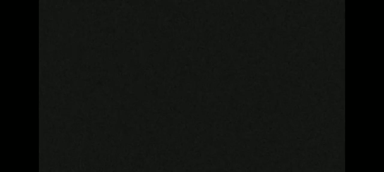 The image shows a dark-grey textured surface.
