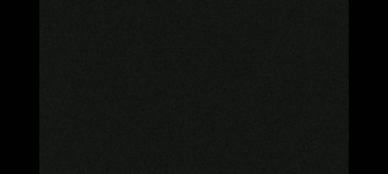 The image shows a dark gray or black textured surface.