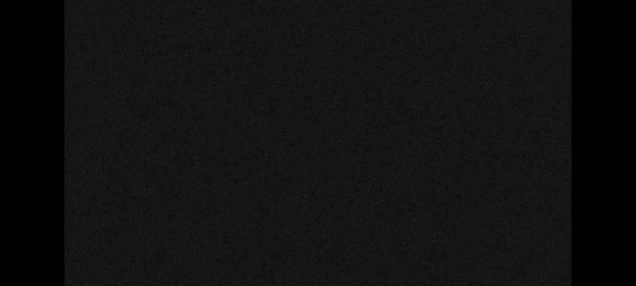 The image shows a dark gray or black textured surface.