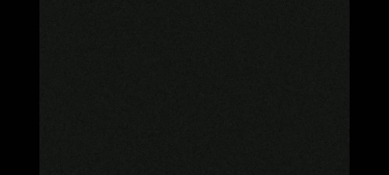 The image shows a dark gray or black textured surface.