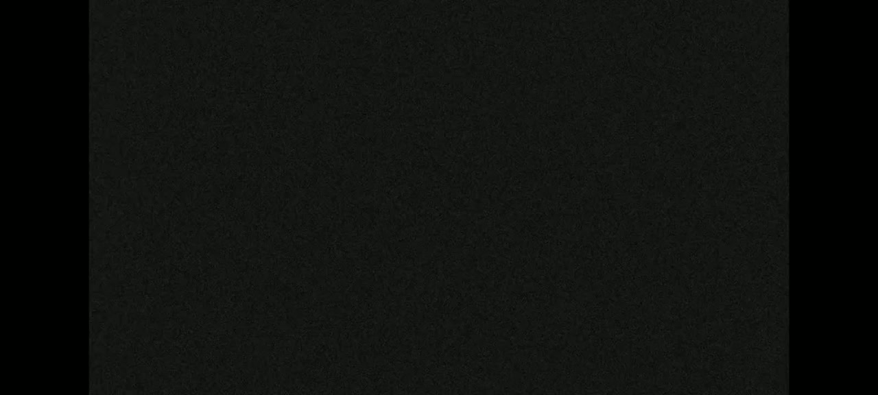 The image shows a dark-colored, textured surface.
