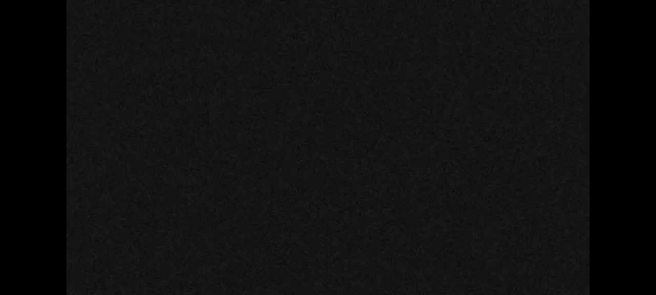 The image shows a dark-grey textured surface.