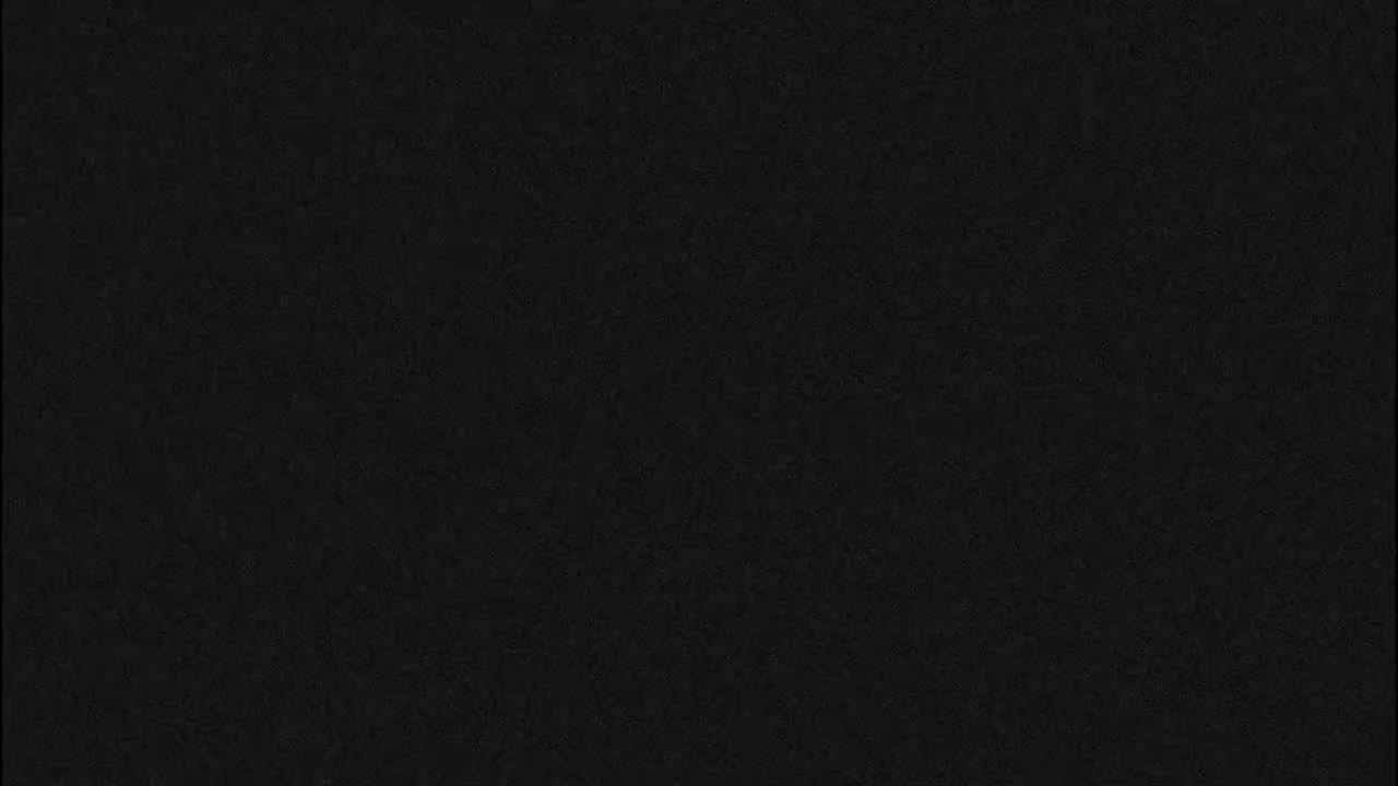 The image is a solid, dark-grey background with a slightly textured surface.