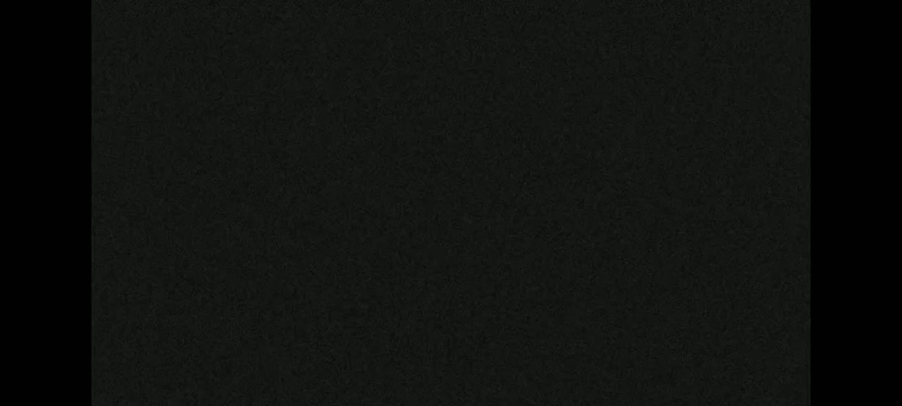 The image shows a dark gray or black textured surface.