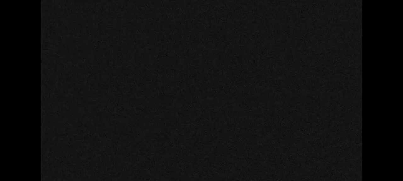 The image shows a dark gray or black textured surface.