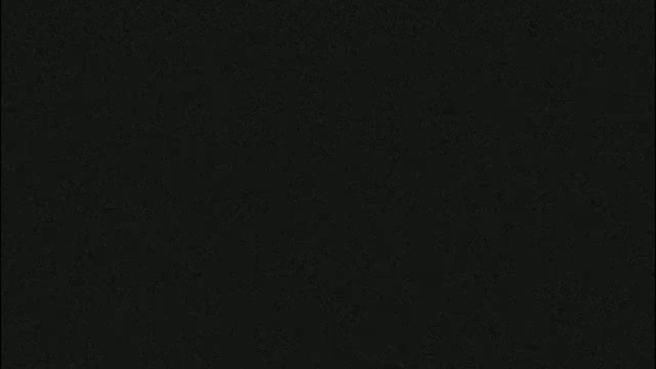 The image is a solid dark-greenish black color.