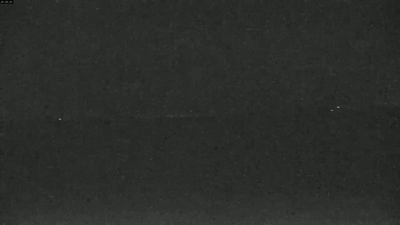 The image shows a dark gray, textured surface with very little visual detail.