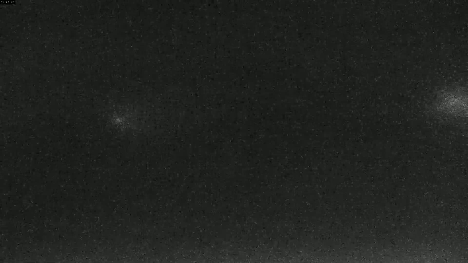A dark, nighttime sky shows two bright lights, possibly stars or planets.