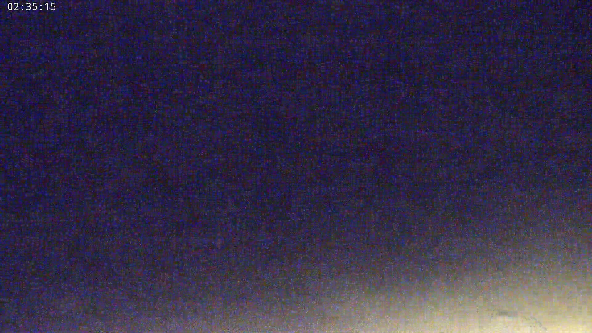 The image shows a dark, nighttime sky with a slight brightening near the horizon.