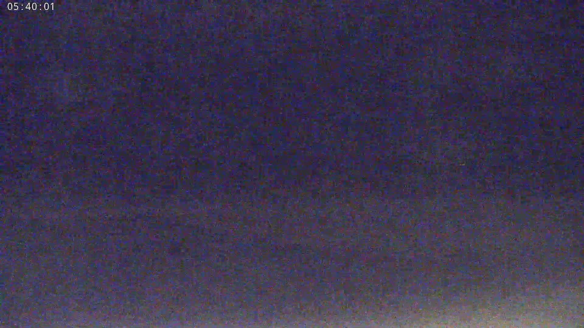 The image shows a dark, possibly nighttime sky with a slightly lighter horizon.